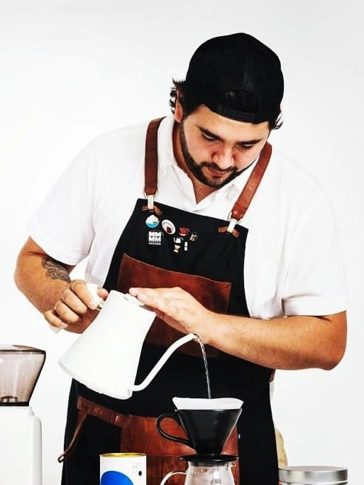 Costa Rican barista champion Emiliano Hellmond makes a pourover.