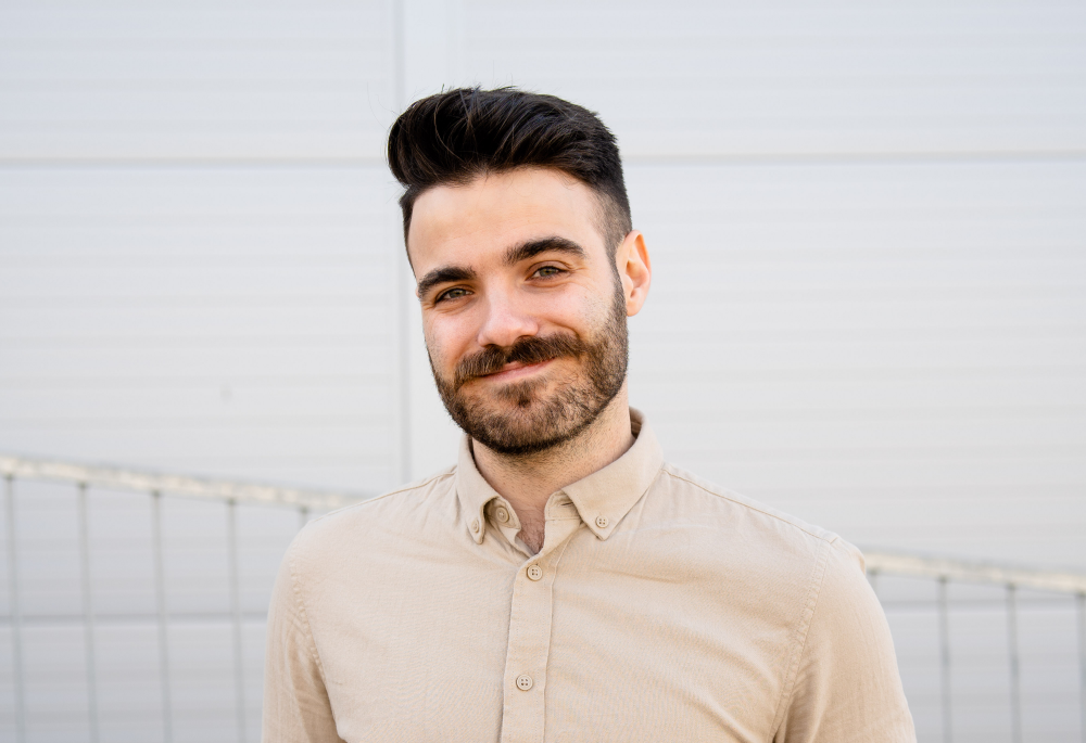 Denis Kramár the barista champion of the Czech Republic in front of a white wall.