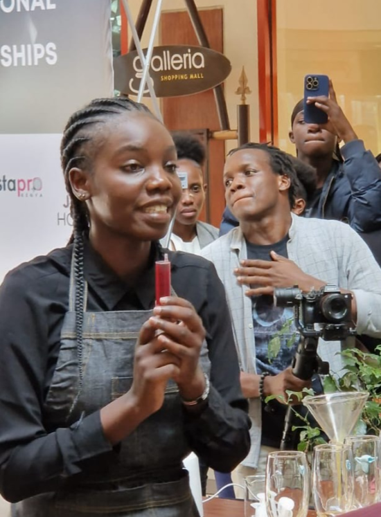 Esther Atieno Ochieng holds a syringe used to create her signature drink at the Kenyan barista championship.