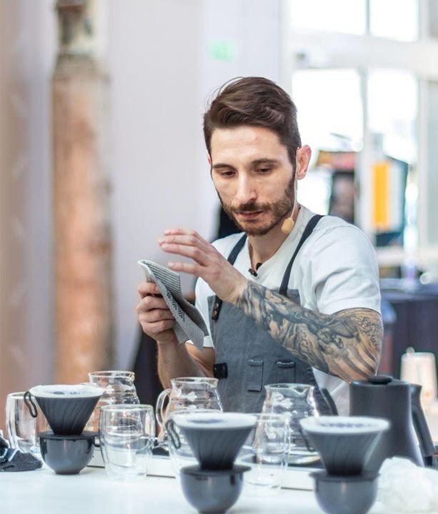 Lakis Psomas reviews his competition set up prior to participating in a barista competition.