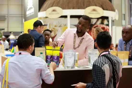 A man shows potential buyers his coffee wares.