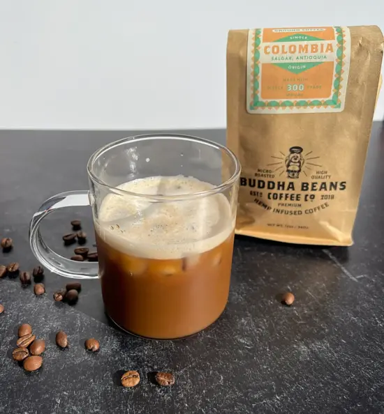 Mug of coffee next to bag of coffee beans.