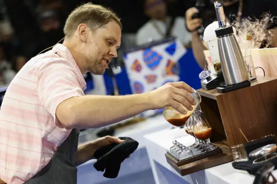 Isaiah talks judges through his beverage as he pours.