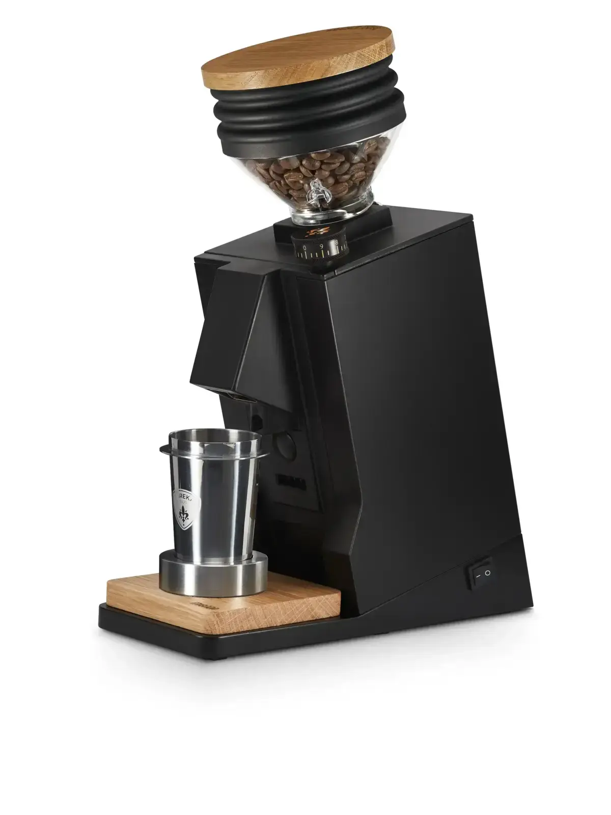 A black grinder with wood base and an unusual black and wooden top that holds beans for dosing.A silver dosing cup is set on a wooden plate at the bottom.