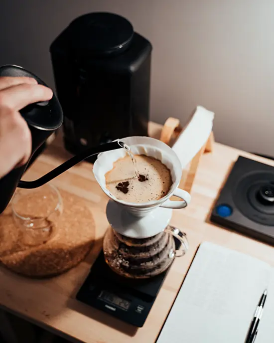 A white Hario V60 pourover setup on a Hario scale.