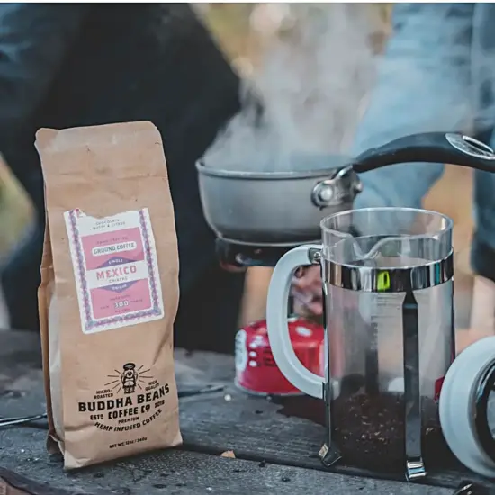 A French press with Buddha Beans coffee bag.