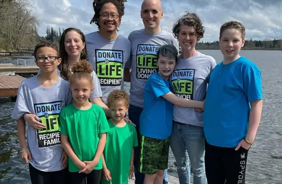 The two families, Lem with three kids and Nathanael with two, pose together by the lake.