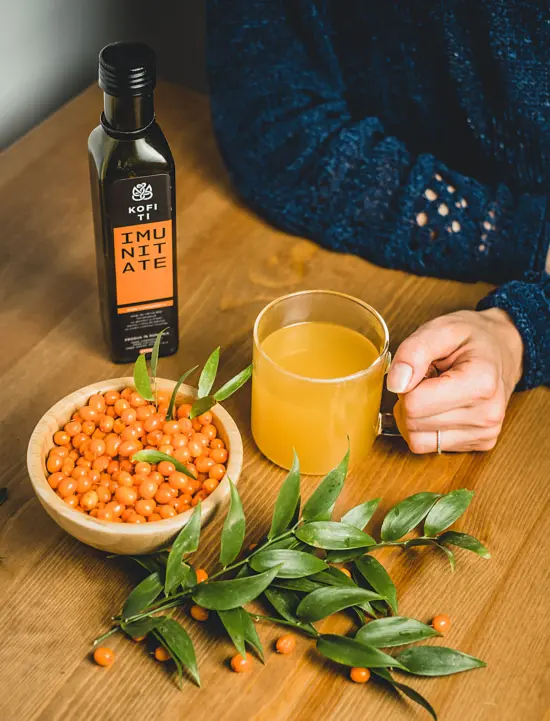 Sea buckthorn with a drink mug and immunity syrup bottle.