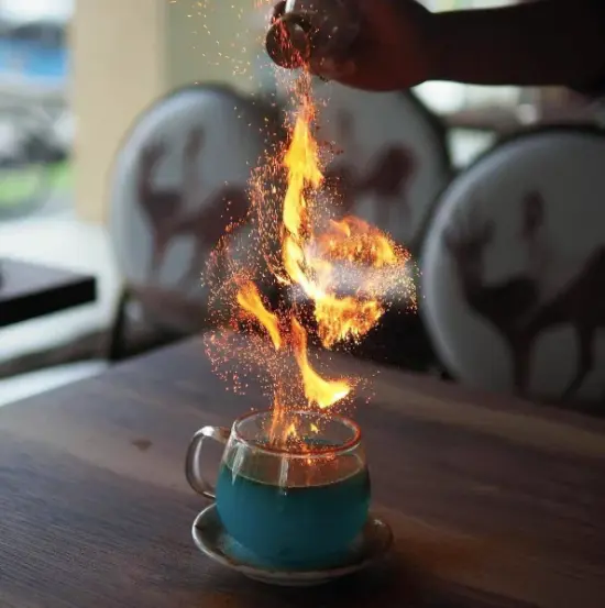 A goblet of fire drink with flames.