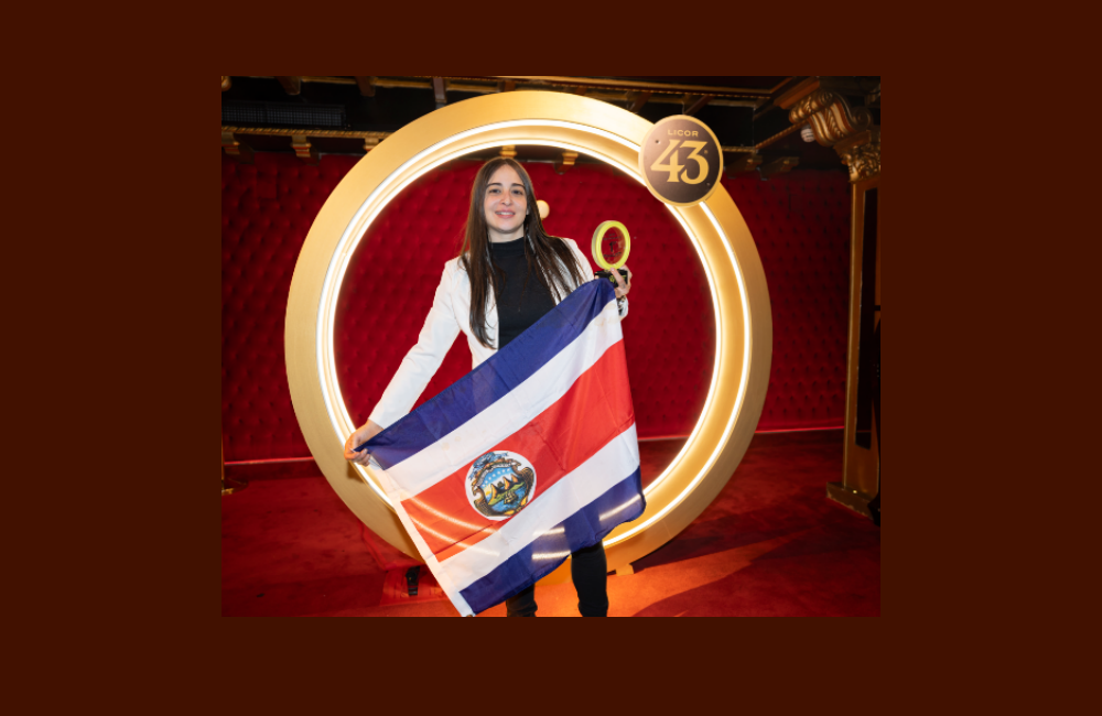 Gabriela Wong champion of the Bartenders & Baristas Challenge holding a Costa Rican flag.