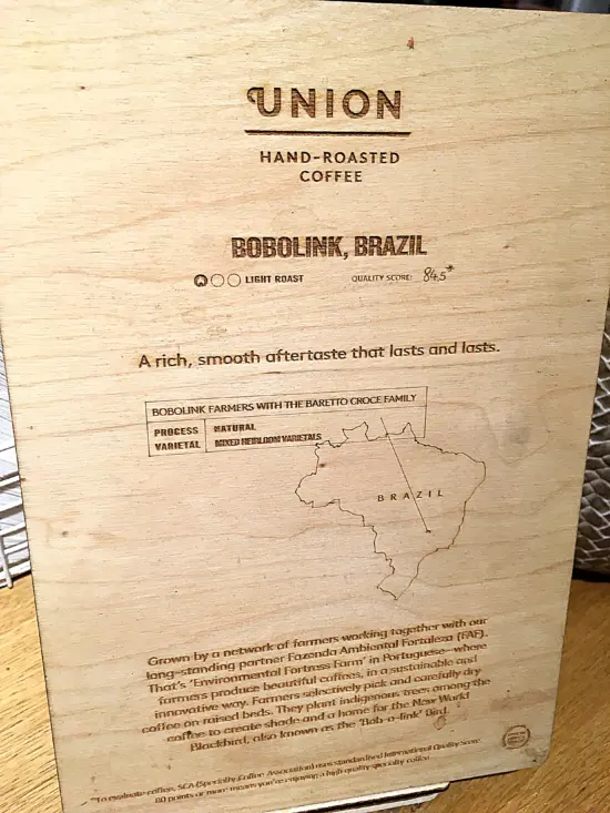 A wooden sign describing a Brazilian coffee at Waterstones Café.