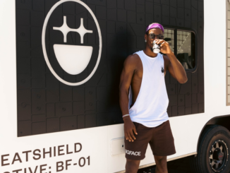 Jimmy Butler drinking coffee outside against a BIGFACE truck.