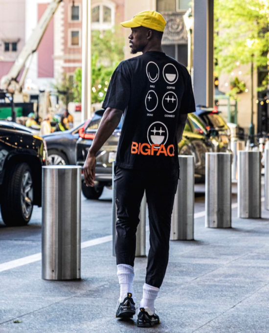 Jimmy Butler walks outside of a hotel wearing a BIGFACE t-shirt.