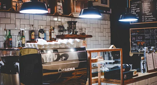 Inside a coffee shop with Faema machine.