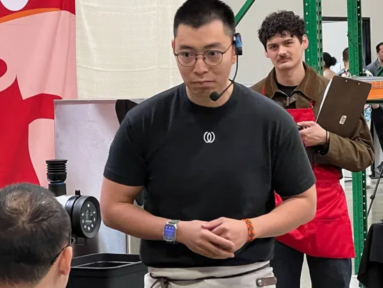 Weihong Zhang talks to the judges during his performance at the Brewers Cup at the U.S. Coffee Championship in Rancho Cucamonga, Calif.