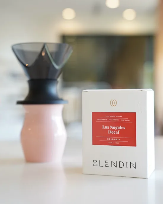 A pourover setup behind the boxed coffee Weihong used in the competetion: Los Nogales Decaf Colombia, with notes of eucalyptus, strawberry, and raspberry.