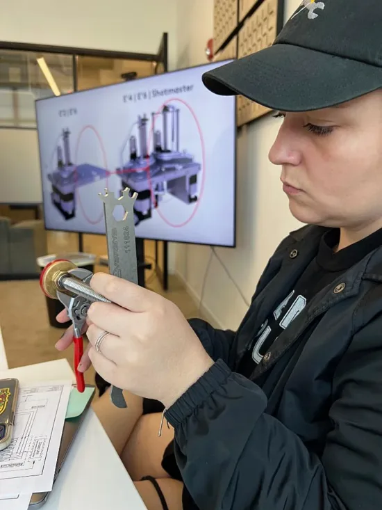 Service Tech Hope Roberts uses a wrench on a piece of equipment.