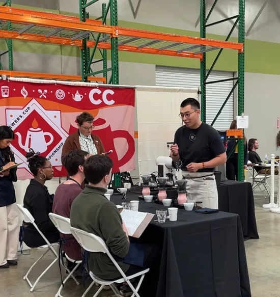 Weihong speaks to judges at Brewers Cup.