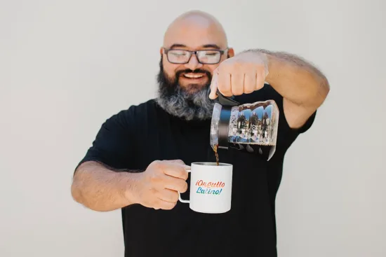 Eduardo pours coffee into a mug.