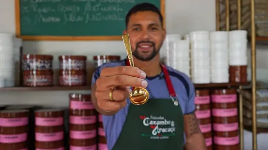 Dionatan holds up a gold cupping spoon.