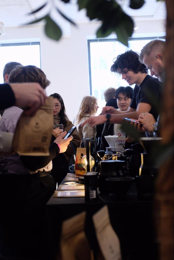 Luka Banovic prepares coffee for a crowd of guests at a catering event.