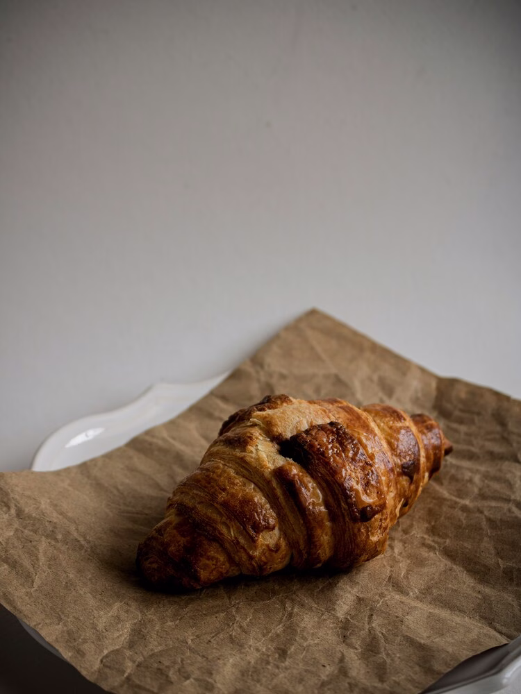 Get Baked: a croissant sits on top of parchment paper