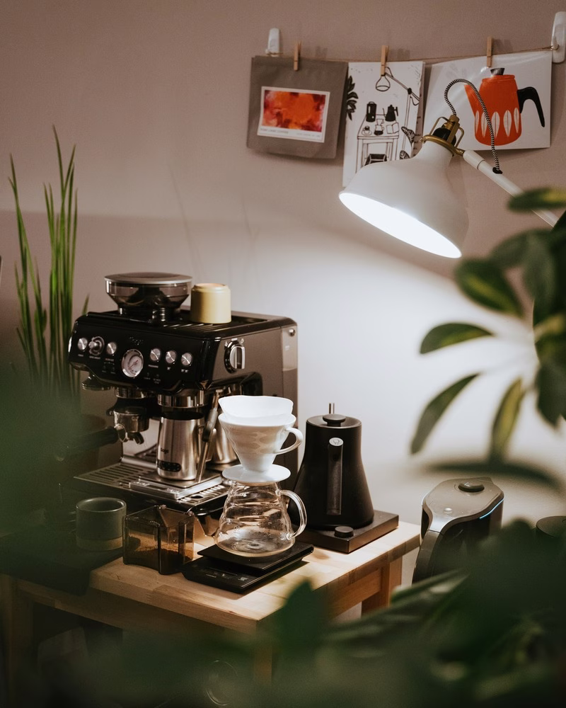 Home-Brewing: Inside of an apartment is an at-home coffee setup, complete with a pourover kit, an espresso machine, and more.