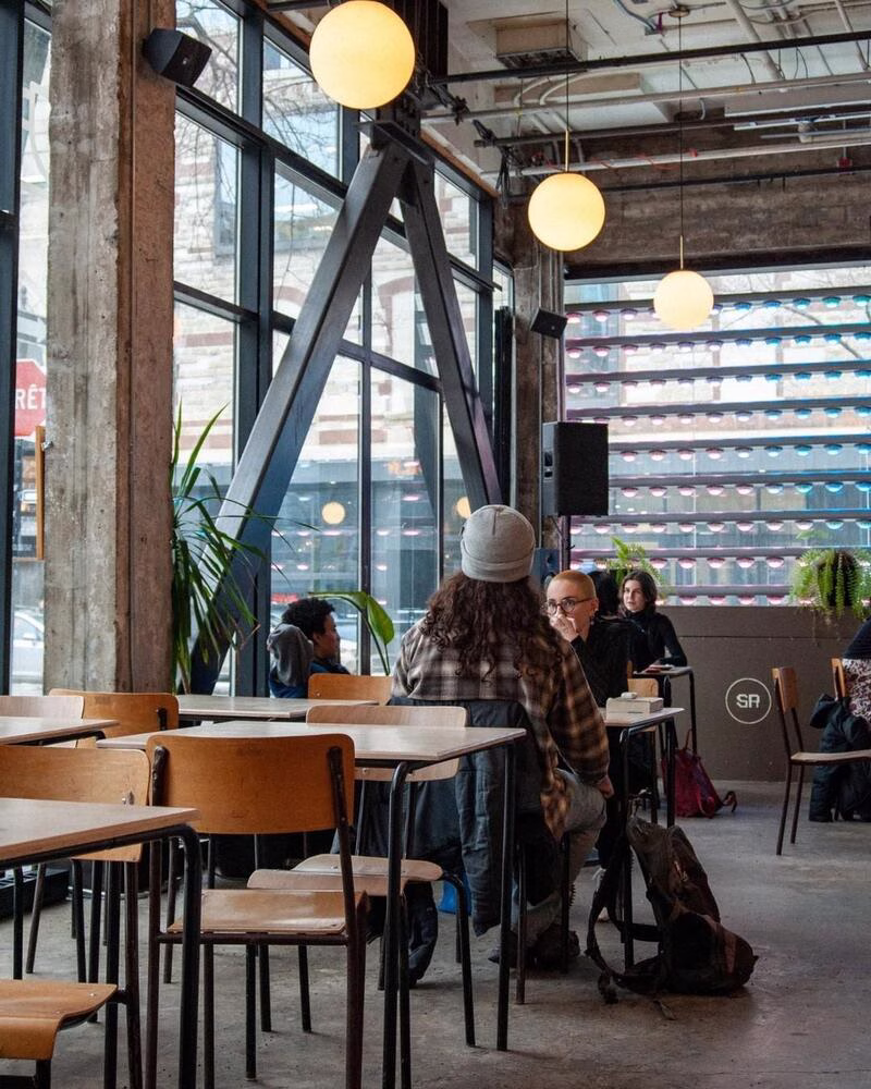 Inside of Café SAT, a brightly lit cafe in Montreal.